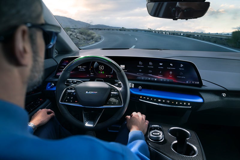 Front View of the 2026 OPTIQ-V Driving Through the Dusk Utilizing its Headlights | Fairfield Cadillac in LEWISBURG PA